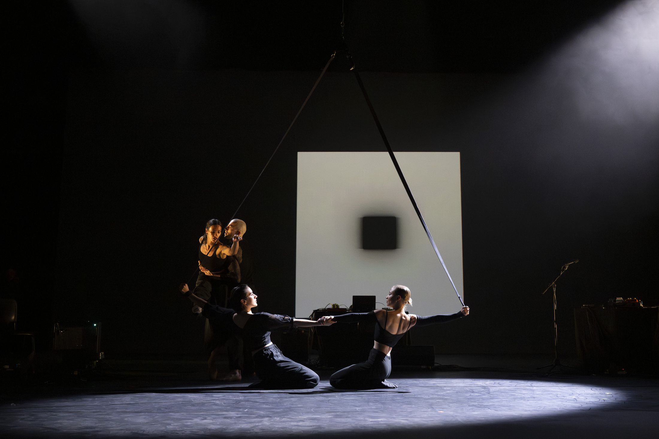 The opening duet on the stage floor, straps rising above