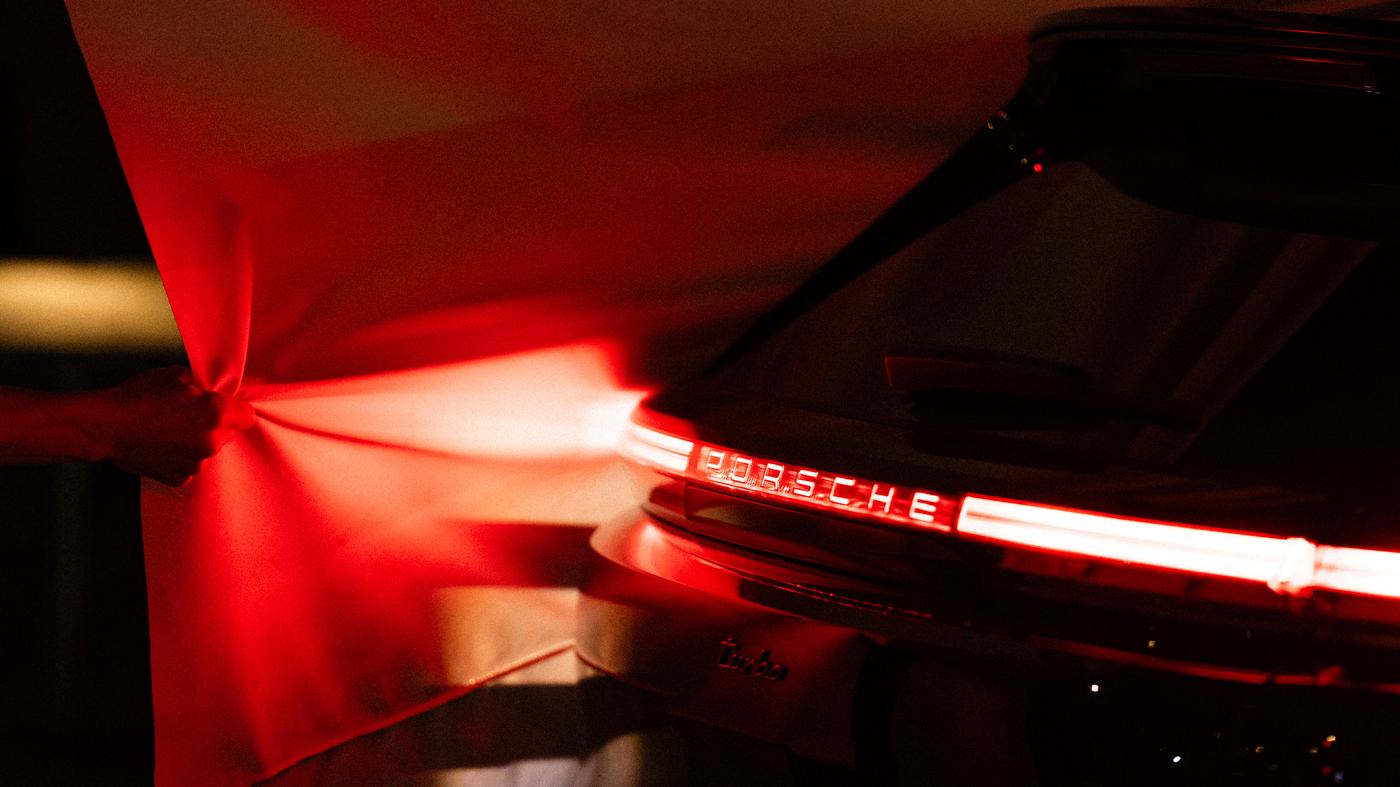 Red light from the car’s rear light bar shining through white fabric