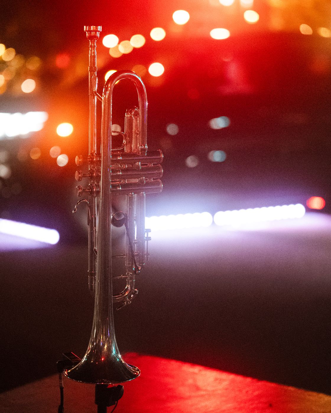 A trumpet on a stand in red light